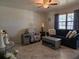 Comfortable living room featuring tile floors, neutral decor, and a window bringing in natural light at 2625 Osage Rd, Venice, FL 34293