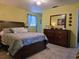 Bright main bedroom features a king bed, large dresser, and natural light at 2625 Osage Rd, Venice, FL 34293