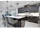 Modern kitchen with a large center island, pendant lighting, stainless appliances, and sleek cabinets at 276 Caserta Ct, North Venice, FL 34275