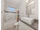 Well-lit bathroom with tub/shower, decorative tile, and sink with granite vanity at 3093 S Haberland Blvd, North Port, FL 34288