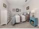 Cozy bedroom with neutral tones, framed art, side table and great natural light at 3093 S Haberland Blvd, North Port, FL 34288