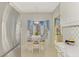 Eat-in kitchen area with white table set for four, large windows and blue patterned wallpaper at 310 Lynbrook Cir # 103, Venice, FL 34292