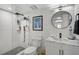 Renovated bathroom with marble countertops and black modern hardware and a glass shower enclosure at 316 Wexford Ter # 167, Venice, FL 34293