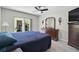 Spacious bedroom with ceiling fan, large window, and dresser for extra storage at 316 Wexford Ter # 167, Venice, FL 34293