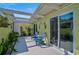 Private courtyard with bright blue Adirondack chairs surrounded by lush tropical plants at 316 Wexford Ter # 167, Venice, FL 34293