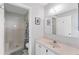 Clean bathroom featuring a walk-in shower, white vanity, and a mirrored cabinet at 3300 Loveland Blvd # 1201, Punta Gorda, FL 33980