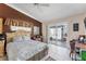 A primary bedroom with a ceiling fan, sliding glass doors, and warm, inviting accents at 3300 Loveland Blvd # 1201, Punta Gorda, FL 33980