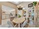 Cozy dining area featuring a chandelier, mirrored walls, and views to kitchen and living area at 3300 Loveland Blvd # 1201, Punta Gorda, FL 33980