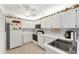 Functional kitchen featuring white cabinetry, black appliances, and ample counter space at 3300 Loveland Blvd # 1201, Punta Gorda, FL 33980