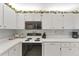 Well-equipped kitchen with white appliances, cabinetry, and plenty of counter space at 3300 Loveland Blvd # 1201, Punta Gorda, FL 33980