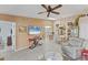 Well-lit living room with open floor plan, tile floors, ceiling fan, and seamless access to the dining area at 3300 Loveland Blvd # 1201, Punta Gorda, FL 33980