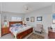 Serene main bedroom with a ceiling fan and a plush, floral-patterned bed at 3300 Loveland Blvd # 1201, Punta Gorda, FL 33980