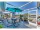 Inviting outdoor patio with dining furniture and a sun umbrella, ideal for entertaining or relaxing outdoors at 3300 Loveland Blvd # 1201, Punta Gorda, FL 33980
