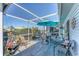 Covered patio featuring comfortable seating and a serene outdoor dining area with views of the neighborhood and flowers at 3300 Loveland Blvd # 1201, Punta Gorda, FL 33980