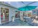 Outdoor patio with seating and an umbrella, perfect for relaxing or dining al fresco with direct access to the house at 3300 Loveland Blvd # 1201, Punta Gorda, FL 33980