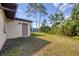 Backyard with some grass and a door to enter from the outside at 3716 Dunbar Rd, Venice, FL 34293