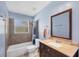 Bathroom featuring a vanity with solid surface counters, tile surround and framed mirror at 3716 Dunbar Rd, Venice, FL 34293