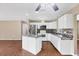 Modern kitchen features a kitchen island, stainless steel refrigerator, and tile backsplash at 3716 Dunbar Rd, Venice, FL 34293