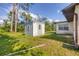 A charming backyard shed and part of the house, sitting on a lush green lawn at 3716 Dunbar Rd, Venice, FL 34293