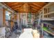 The inside of a shed with a lawn mower, ladder, and shelves for storage at 3716 Dunbar Rd, Venice, FL 34293