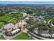 Expansive aerial view of the golf course and clubhouse surrounded by lush landscaping and serene lakes at 385 N Point Rd # 404, Osprey, FL 34229