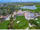 Aerial view of a golf course featuring lush fairways, beautiful landscaping, and an elegant clubhouse at 385 N Point Rd # 404, Osprey, FL 34229