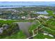 Breathtaking aerial view of the golf course, lakes, tennis courts, and community buildings in a vibrant community at 385 N Point Rd # 404, Osprey, FL 34229