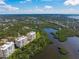 Scenic aerial view of condos by a lake, highlighting the community's natural setting at 385 N Point Rd # 404, Osprey, FL 34229