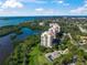 Stunning aerial view of the luxury waterfront condos surrounded by lush greenery and bay waters at 385 N Point Rd # 404, Osprey, FL 34229