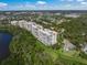 Aerial view of luxurious condos surrounded by lush greenery and lake at 385 N Point Rd # 404, Osprey, FL 34229