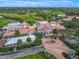 Aerial view of The Oaks Club, featuring its luxurious clubhouse and golf course at 385 N Point Rd # 404, Osprey, FL 34229