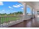 Beautiful veranda has columns overlooking a golf course at 385 N Point Rd # 404, Osprey, FL 34229