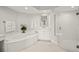 Bright bathroom featuring a soaking tub, glass shower and double vanity at 385 N Point Rd # 404, Osprey, FL 34229