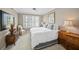 Bedroom featuring neutral walls, large window with shutters and beautiful furnishings at 385 N Point Rd # 404, Osprey, FL 34229