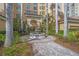 Building entrance with a water fountain, landscaping, and brick walkway at 385 N Point Rd # 404, Osprey, FL 34229