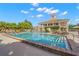 Enjoy the community pool with surrounding lounge chairs and clubhouse, perfect for relaxation and social gatherings at 385 N Point Rd # 404, Osprey, FL 34229
