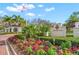 Entrance to The Oaks Club featuring colorful flowers and greenery at 385 N Point Rd # 404, Osprey, FL 34229