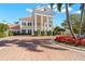 Grand estate with stately columns, lush landscaping, and a circular brick driveway, perfect for elegant living at 385 N Point Rd # 404, Osprey, FL 34229