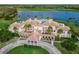 Stunning lakefront property featuring a resort-style pool, lush landscaping, and a private courtyard at 385 N Point Rd # 404, Osprey, FL 34229