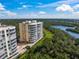 Beautiful high rise waterfront property with balconies and lush greenery, offering serene views at 385 N Point Rd # 404, Osprey, FL 34229
