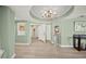 Elegant foyer featuring a chandelier, artwork, and light wood-look floors at 385 N Point Rd # 404, Osprey, FL 34229