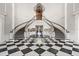 Grand foyer features dramatic staircase, black and white marble floors and chandelier at 385 N Point Rd # 404, Osprey, FL 34229