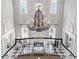 View from above of the foyer with checkerboard floor and dramatic chandelier at 385 N Point Rd # 404, Osprey, FL 34229