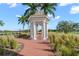 Picturesque gazebo nestled among palm trees and lush landscaping, offering a serene spot to relax and enjoy the outdoors at 385 N Point Rd # 404, Osprey, FL 34229