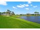 Scenic view of the lush green golf course winding along a tranquil lake, providing a picturesque backdrop for golfers at 385 N Point Rd # 404, Osprey, FL 34229