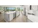 Contemporary kitchen showcasing stainless steel appliances, a large island, and sleek white countertops at 385 N Point Rd # 404, Osprey, FL 34229
