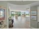 Open-concept living space with wood floors, balcony access, dining area, and a modern kitchen at 385 N Point Rd # 404, Osprey, FL 34229
