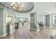 Bright and airy living room with wood floors, a decorative chandelier, and stunning views of the water at 385 N Point Rd # 404, Osprey, FL 34229