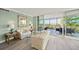 Comfortable living room featuring modern furniture, soft colors, wood floors, and balcony access at 385 N Point Rd # 404, Osprey, FL 34229