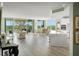 Spacious open-concept living area with a modern kitchen, dining area, and sliding door to a large balcony at 385 N Point Rd # 404, Osprey, FL 34229